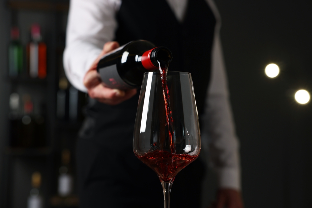 Professional,Sommelier,Pouring,Red,Wine,Into,Glass,Indoors,,Closeup